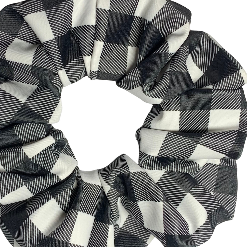 Close up of black and white checkered swim scrunchies on a white background