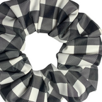 Close up of black and white checkered swim scrunchies on a white background