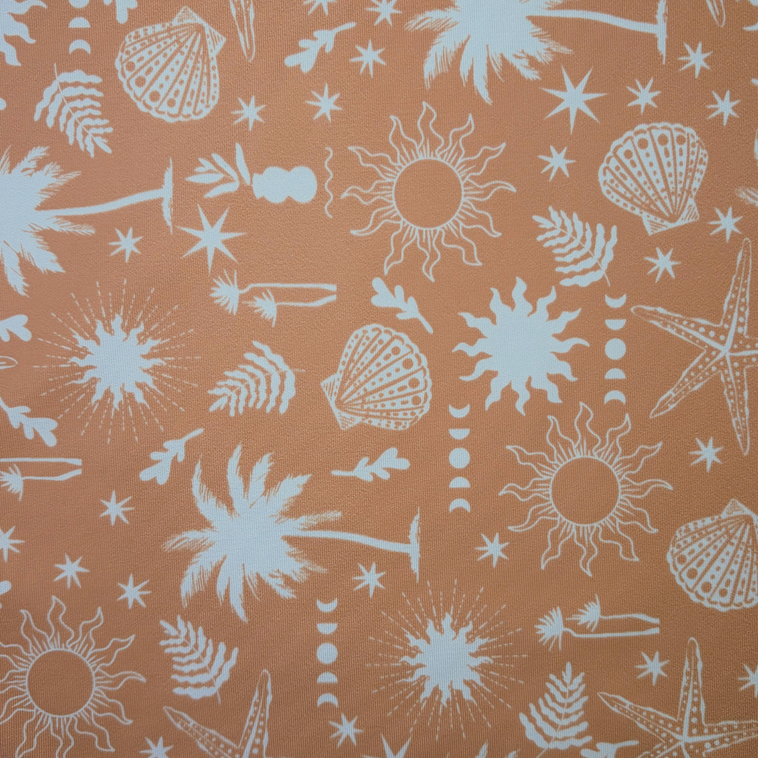 A close-up of a fabric pattern featuring white beach-themed illustrations, including palm trees, starfish, seashells, suns, and small leaves, printed on a warm peach-orange background.