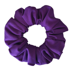 A single purple fabric scrunchie with a soft, gathered texture, shown against a plain white background.
