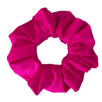 A bright hot pink satin hair scrunchie, photographed flat against a solid white background.