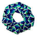 Blue and green mermaid patterned scrunchie on a white background