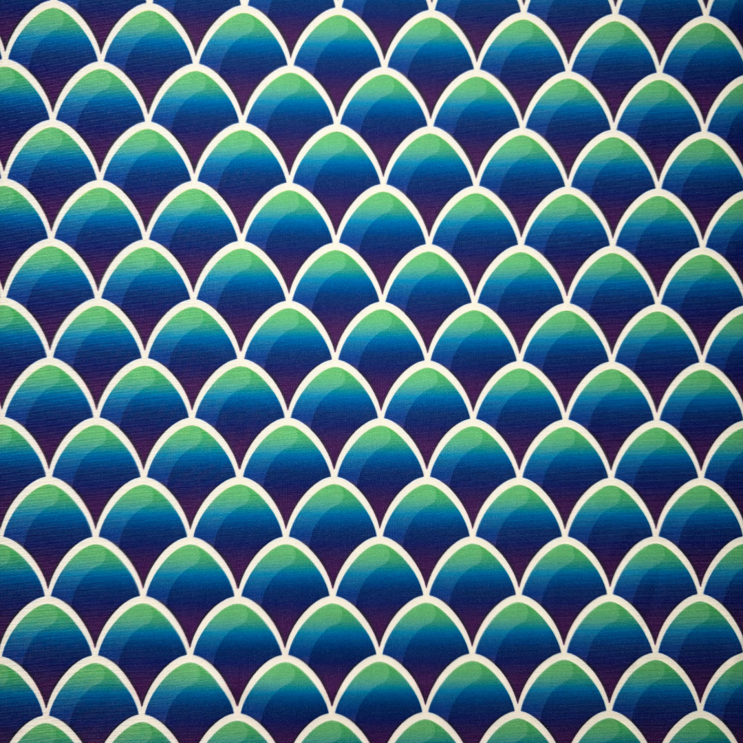 Pattern of blue and green mermaid scales on a dark blue background