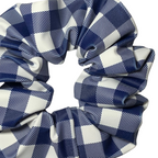 Close up of blue and white checkered swim scrunchies on a white background