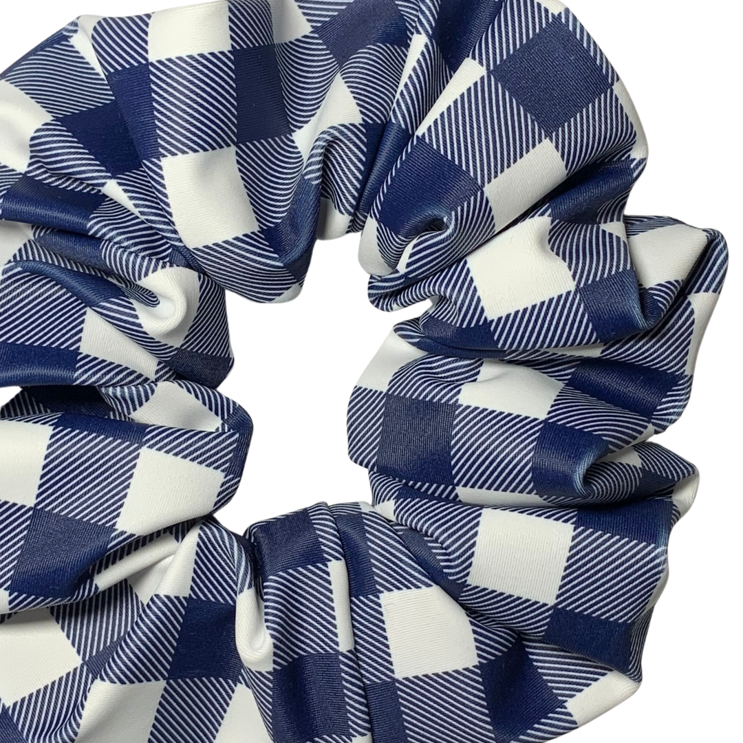 Close up of blue and white checkered swim scrunchies on a white background