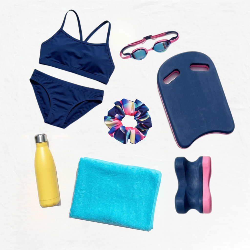 Collection of swim gear including a navy bikini, goggles, swim fins, a towel, and a water bottle on a white background.