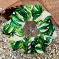 Green leaf-patterned scrunchie on a textured surface