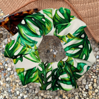 Green leaf-patterned scrunchie on a textured surface