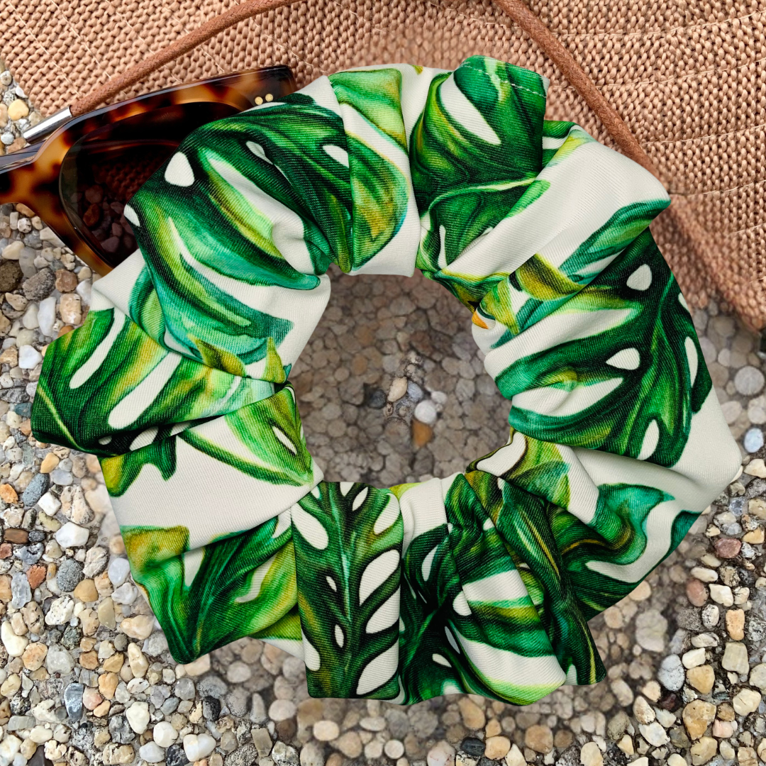 Green leaf-patterned scrunchie on a textured surface
