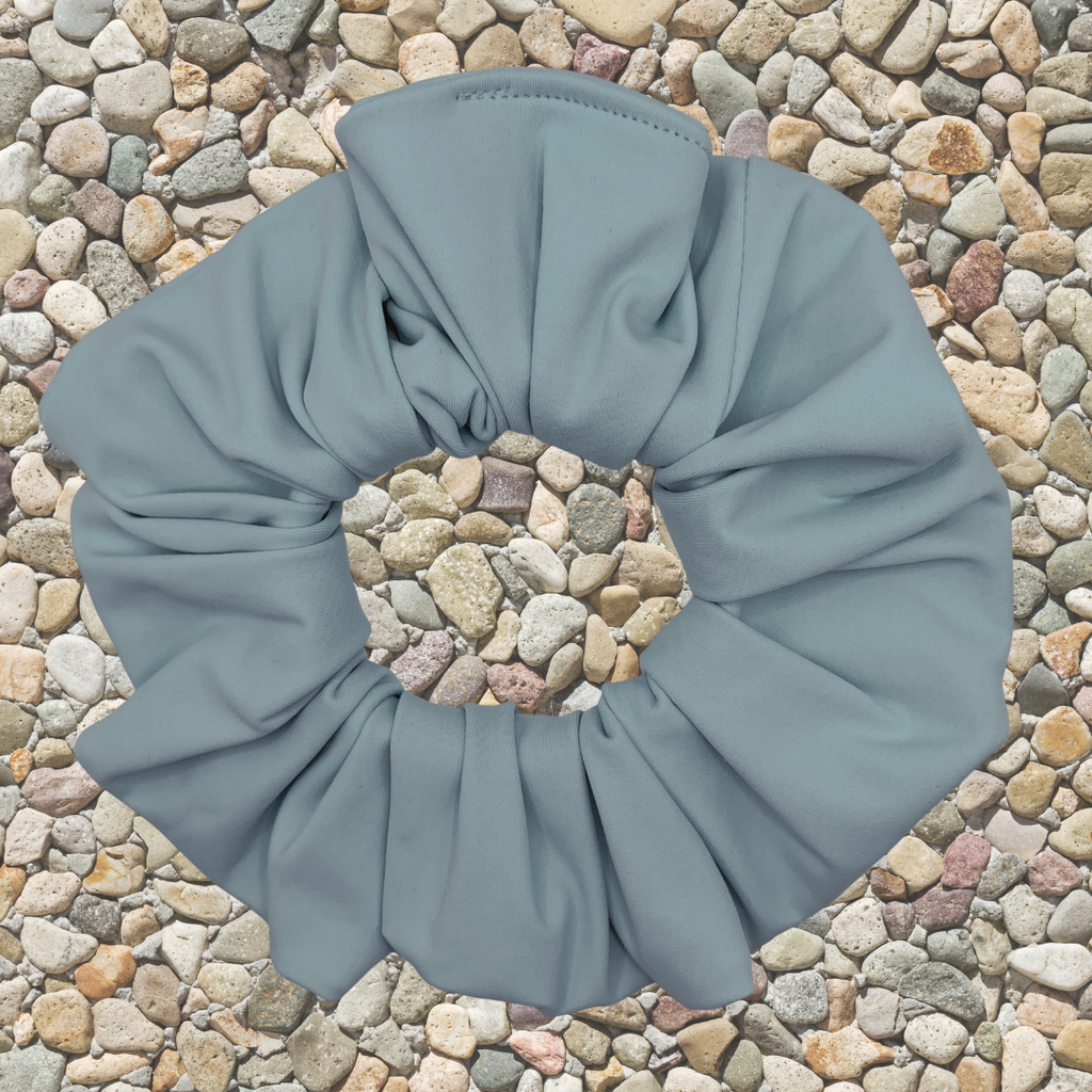 sky Blue scrunchie on a textured stone background