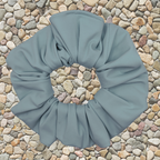 sky Blue scrunchie on a textured stone background