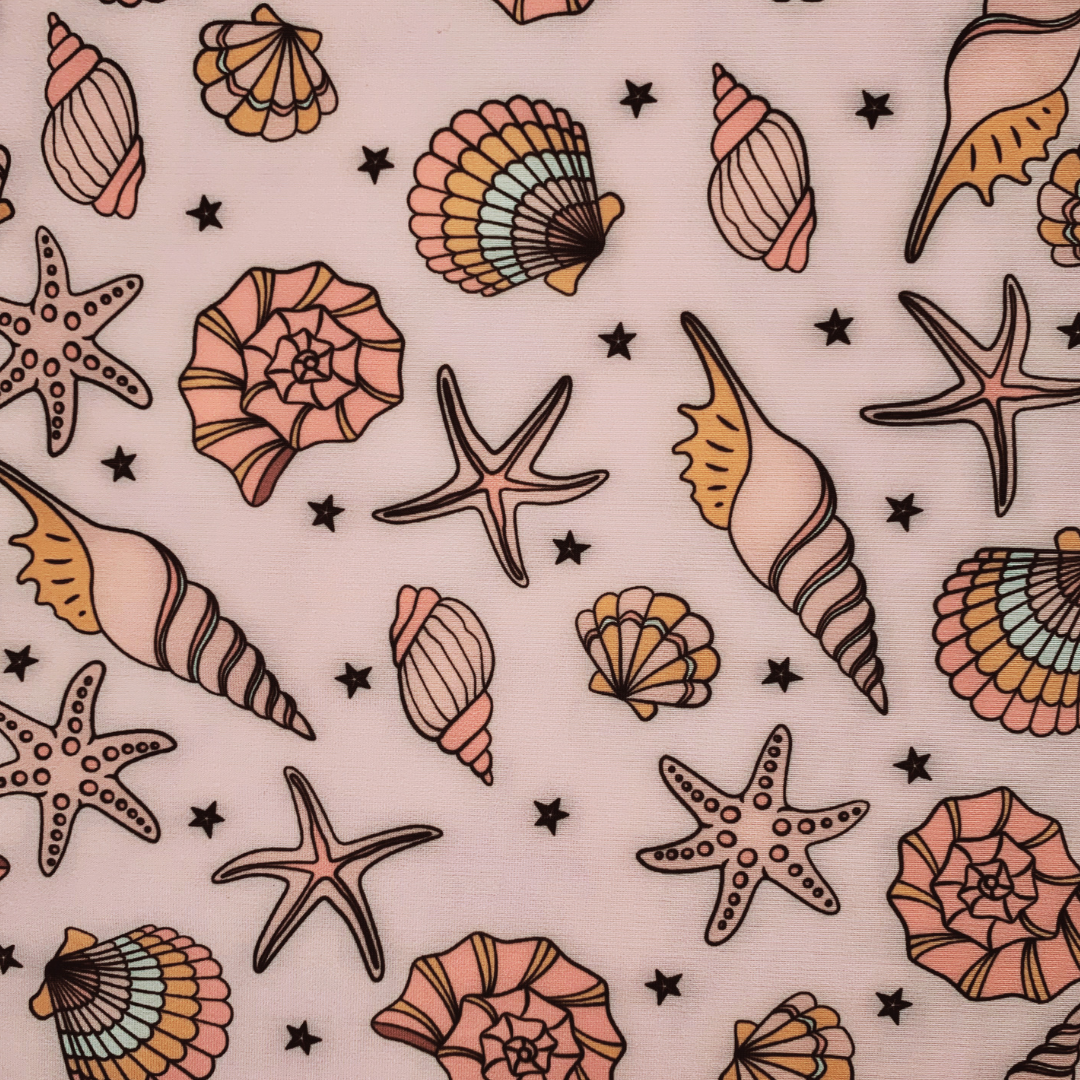 Pattern of seashells and starfish on a pink background