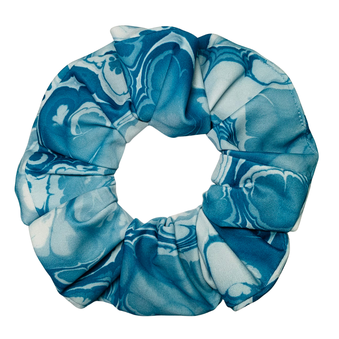 Blue and white patterned scrunchie on a white background