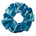 Blue and white patterned scrunchie on a white background