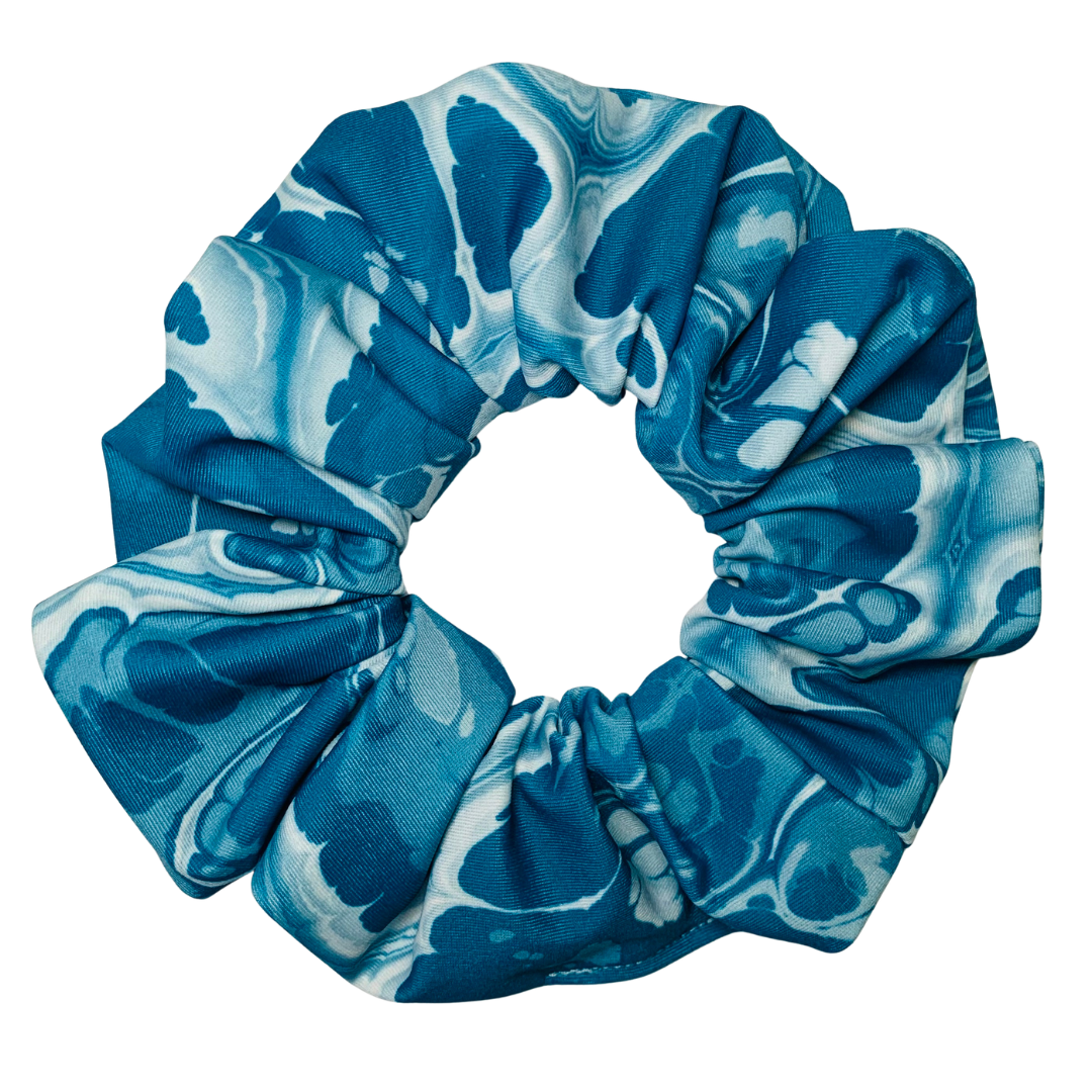 Blue and white patterned scrunchie on a white background