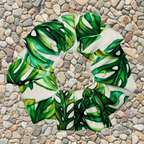 Decorative stone with green leaf pattern on a pebble background