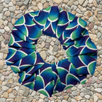 Blue and green mermaid patterned scrunchie on a stone surface