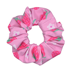 Pink scrunchie with strawberry pattern on a white background
