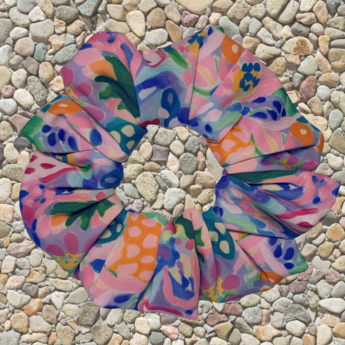 Colourful floral swim scrunchie on a pebble surface