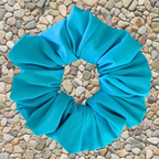 Aqua scrunchie on a pebble background