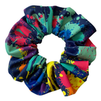 Multicolored abstract swim scrunchie with a splatter pattern on a white background