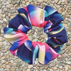 Neon bubble pattern swim scrunchie on a stone surface