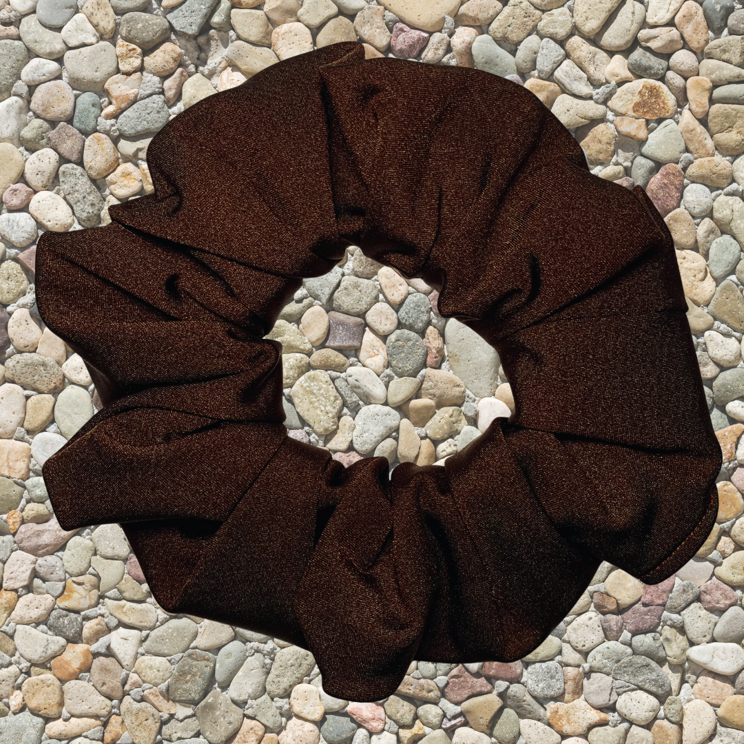 Chocolate Swim Scrunchie on a pebble background