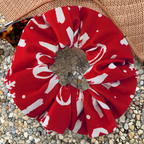 Christmas red and white ho ho ho swim scrunchie on a pebble surface