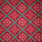 Red and green fabric pattern with snowflakes