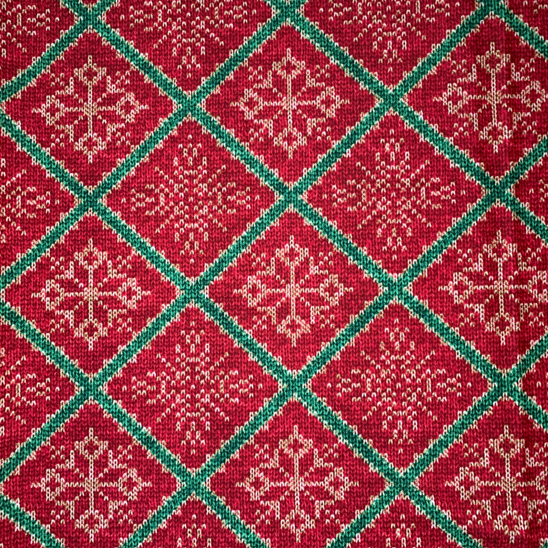 Red and green fabric pattern with snowflakes