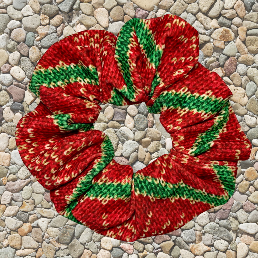 Red and green christmas swim scrunchie on a pebble surface