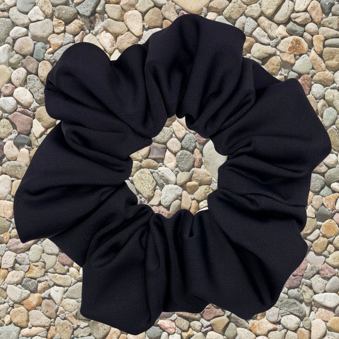 Black scrunchie on a textured surface 