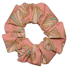 Pink seashell swim scrunchie on a white background