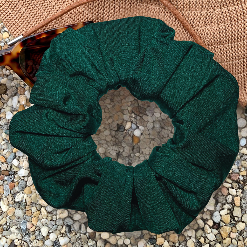 Emerald Green Swim Scrunchie on a textured surface with sunglasses and a hat