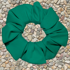 Green swim scrunchie on a pebble background