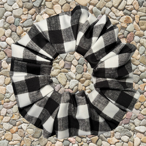 Black and white checkered scrunchie on a stone surface