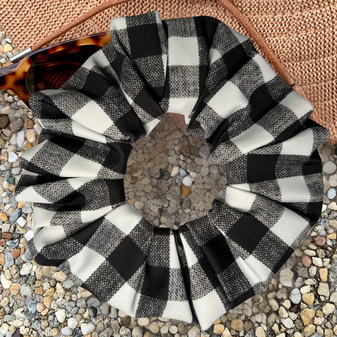 Black and white checkered scrunchie on a textured surface
