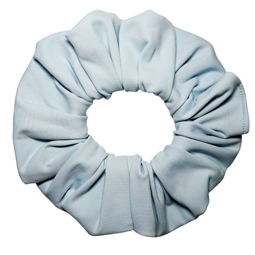 A single light blue fabric scrunchie photographed on a plain white background.