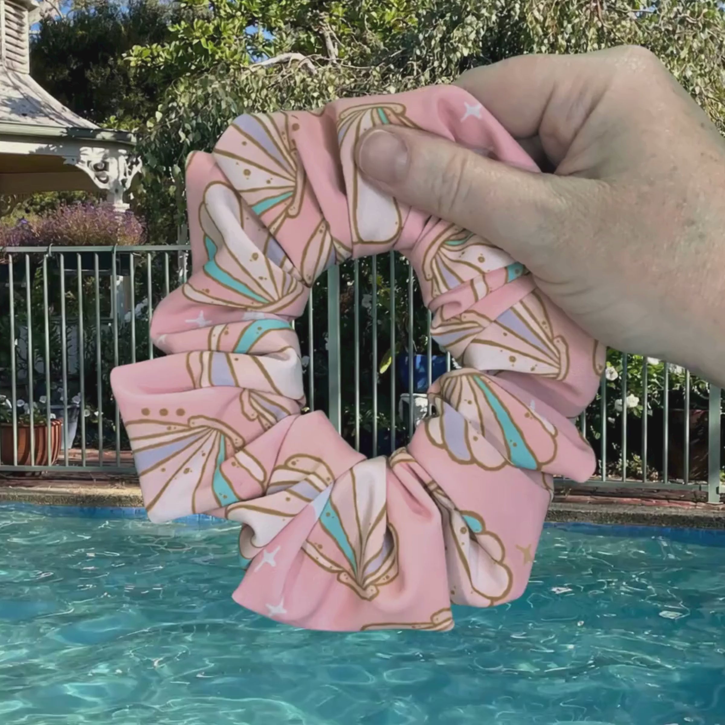 Swim scrunchie being dipped into pool water