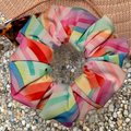 Colourful striped swim scrunchie on a textured surface