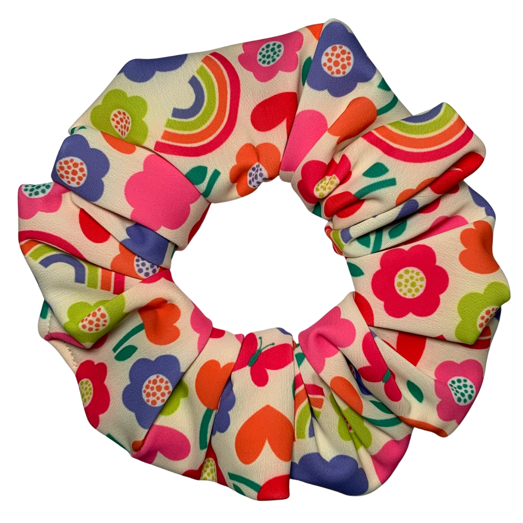 Colourful floral and rainbow patterned scrunchie on a white background