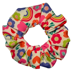 Colourful floral and rainbow patterned scrunchie on a white background
