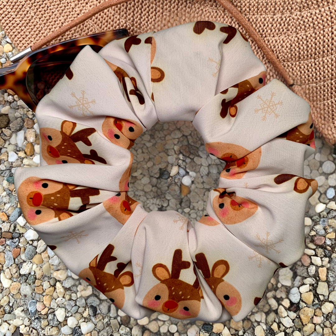 Swim Scrunchie with reindeer pattern on a textured surface