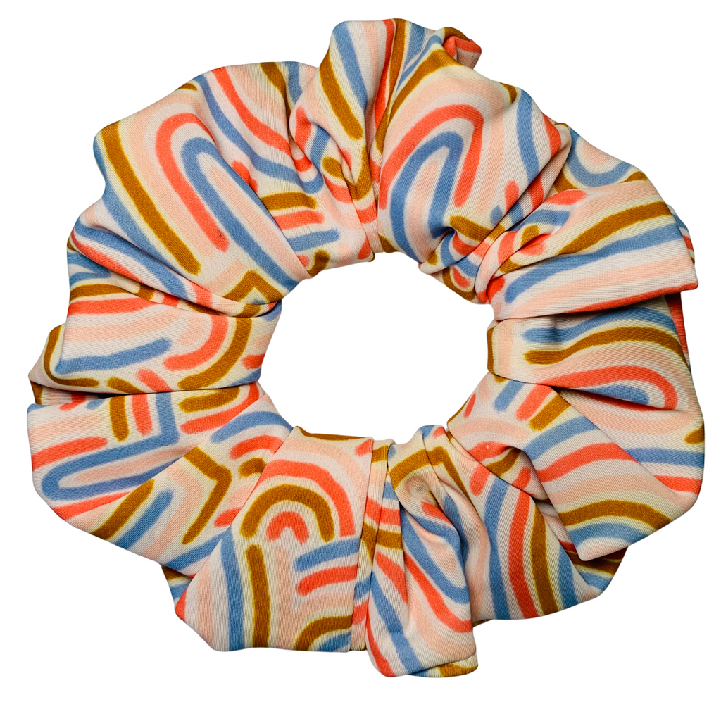 Colourful scrunchie with abstract pattern on a white background