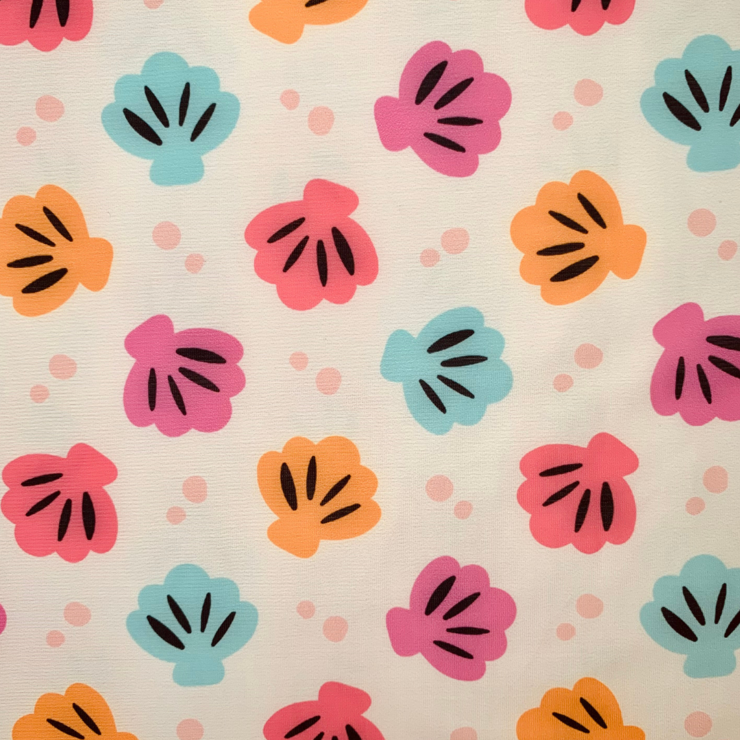 Pattern of colourful shells on a beige background