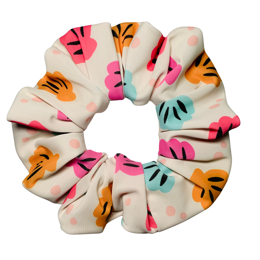 Swim scrunchie with colourful shell pattern on a white background