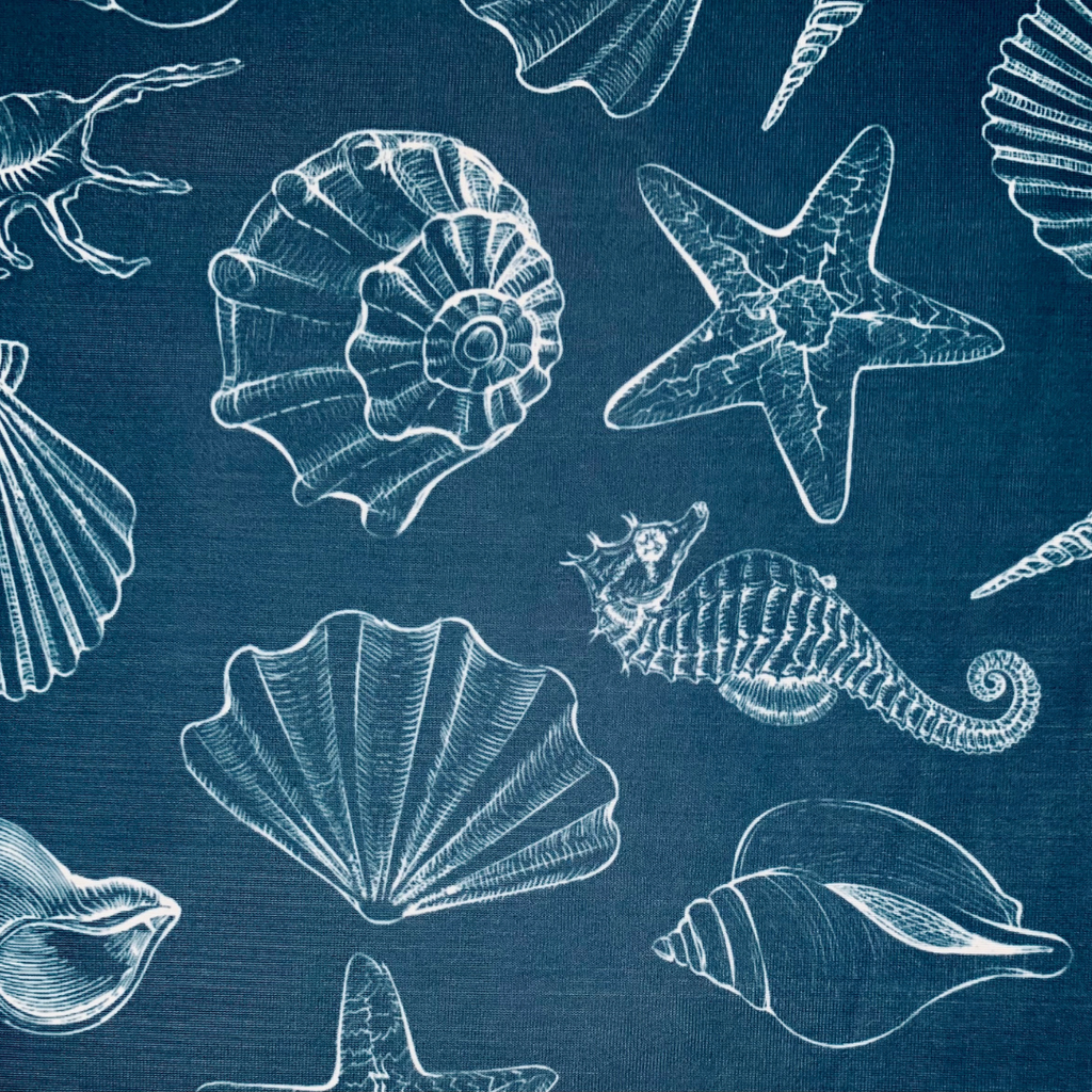 Pattern of white sea shells and starfish on a blue background