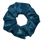 Blue swim scrunchie with white patterns of sea life and shells pattern on a white background