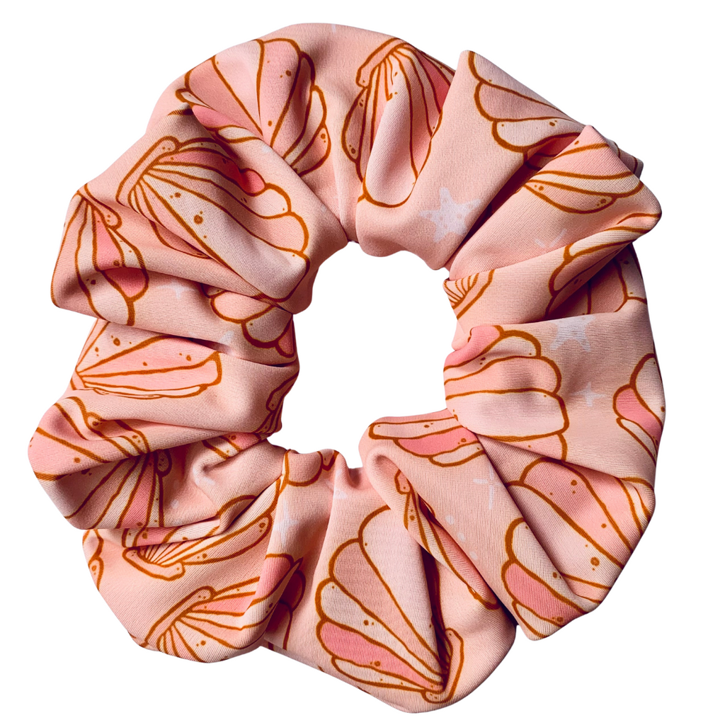 Pink swim scrunchie with shell pattern on a white background
