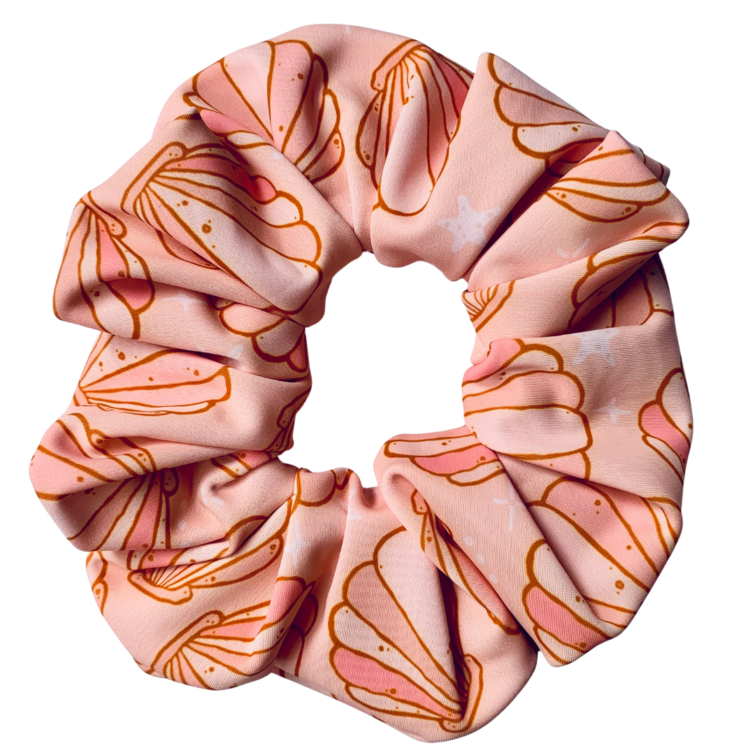Pink swim scrunchie with shell pattern on a white background